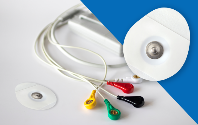 olter ECG lead wires with color-coded snap connectors and disposable electrodes on a table; electrode snap close-up.