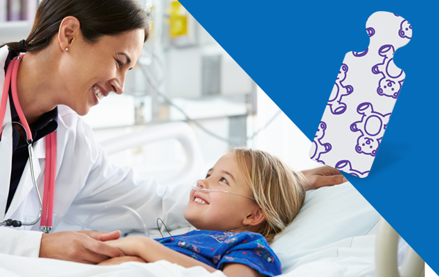 linician checking a pediatric patient in a hospital bed with ECG leads; pediatric tab electrode with playful pattern.