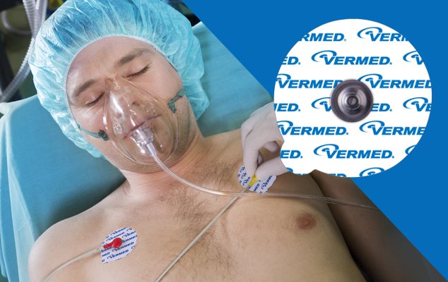 Patient lying down for a resting ECG while a clinician applies a chest electrode; round Vermed electrode close-up.